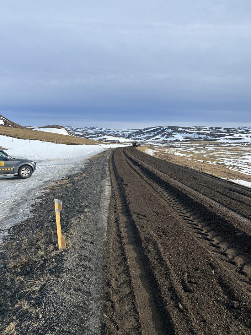 Unnið er að því að fræsa slitlag á löngum köflum saman við burðarlag. Þar með verður vegurinn að malarvegi.
